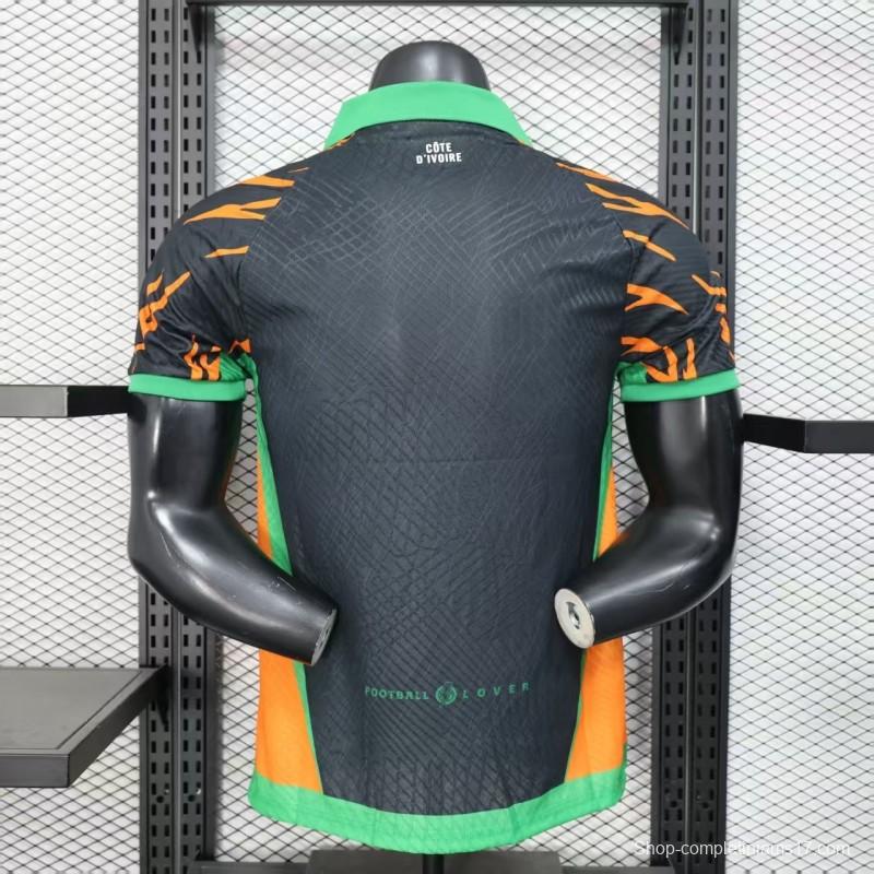 Player Version 2025 Ivory Coast Black with Elephant Graphic and Orange Stripes Jersey